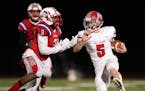 Elk River quarterback Zach Stroh (5) braced for the tackle by Robbinsdale Armstrong defensive back Francis Sesay (3) as he rushed the ball in the fist