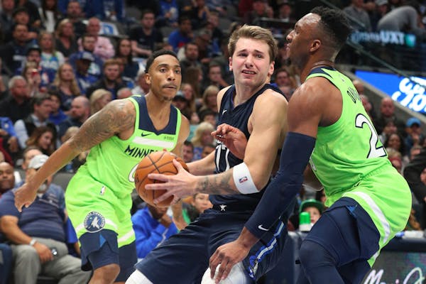 Dallas forward Luka Doncic tried to get past Timberwolves guard Josh Okogie for a shot in the second quarter.