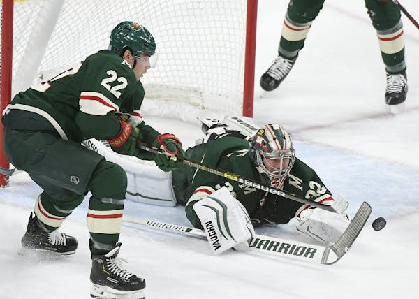 Minnesota Wild goaltender Alex Stalock (32) leapt forward for a save with the help of left wing Kevin Fiala (22) in the second period.
