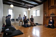 Meditation instructor Carri Garcia, right, led practitioners in a meditation and instruction session in the main meditation hall at the Minnesota Zen 