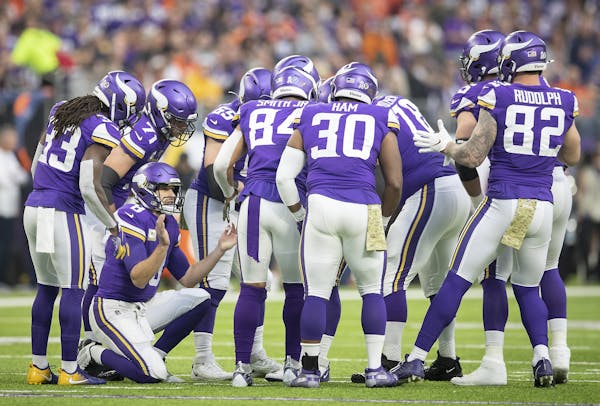 Minnesota Vikings' quarterback Kirk Cousins called plays in the huddle in the first quarter.