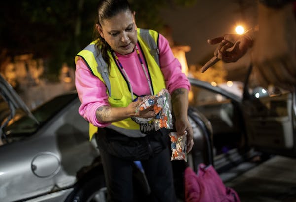 Linda, known as “Moms” on the streets, handed out clean syringes in the Phillips community in September. Linda and her fiance, Mark, go out four t