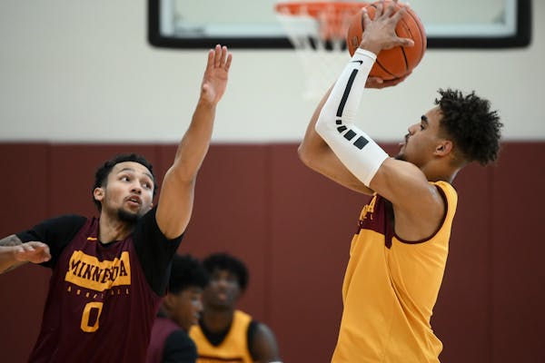 Freshman guard Tre’ Williams (shooting against Payton Willis in practice) has shown potential as a long-range shooter for the Gophers, but he needs 