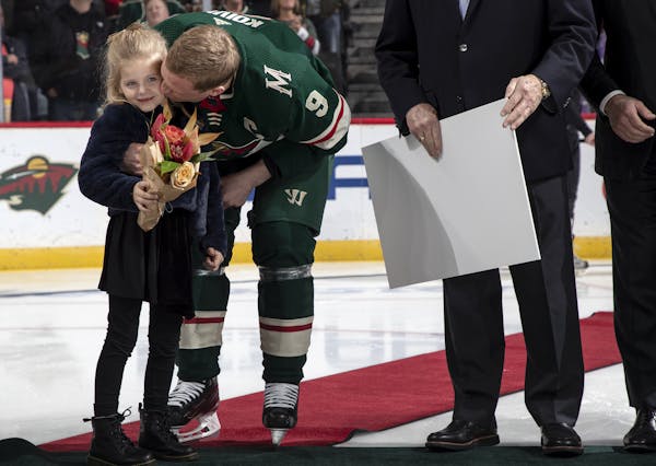 Wild captain Mikko Koivu gave his daughter a kiss as he was honored Tuesday night at Xcel Energy Center for having played 1,000 games.