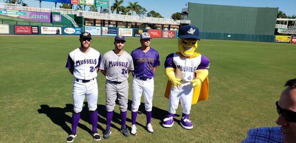 Twins minor-leaguer prospects Trey Cabbage, Alex Kirilloff and Jordan Balazovic pose with the Mighty Mussels mascot on Tuesday.