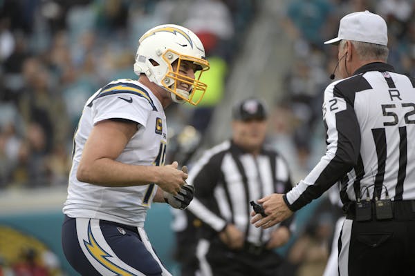 Chargers quarterback Philip Rivers talked with referee Bill Vinovich during Sunday’s game in Jacksonville.