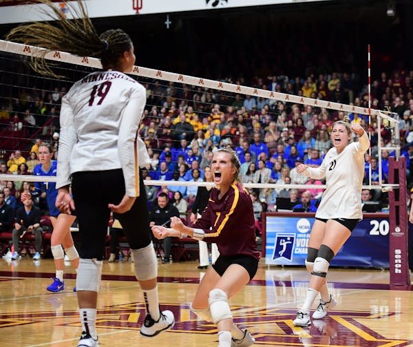 From left, Gophers outside hitter Alexis Hart (19), libero CC McGraw (7) and middle blocker Regan Pittman (21) celebrated a third set kill by Hart aga