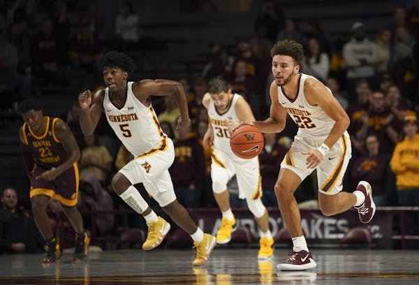 Guard Gabe Kalscheur (22), who hit five of the Gophers' 14 three-pointers, leads Minnesota's fast break in the second half.
