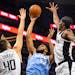 Timberwolves center Karl-Anthony Towns puts up a shot against pressure from the Los Angeles Clippers' Ivica Zubac