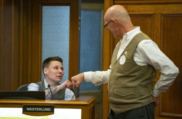 Duluth City Council Members Em Westerlund, left, and Gary Anderson fist bumped before their session on Monday where the council approved a ban on conv