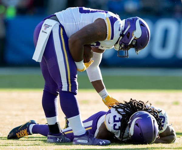 The Vikings C.J. Ham checked on teammate Dalvin Cook, who was injured on a run in the third quarter.