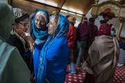Gurpreet Kaur, who gave a sermon on the equality of men and women, a fundamental tenet of the Sikh faith is greeted by Bash Singh who praised her and 