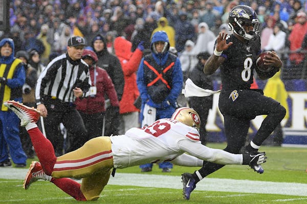 Baltimore quarterback Lamar Jackson was forced out of bounds by 49ers tackle DeForest Buckner on Sunday during the Ravens’ victory.