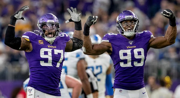 Minnesota Vikings' Everson Griffen (97) and Danielle Hunter (99) celebrated after Hunter sacked Lions quarterback David Blough