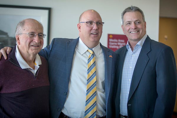 Upon his hiring as Gophers men's hockey coach in 2018, Bob Motzko was flanked by Doug Woog, left, the coach from 1985-99, and Don Lucia, the coach fro