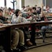 Elliott Tanner, 11, raises his hand to ask a question during his calculus four class at the University of Minnesota.