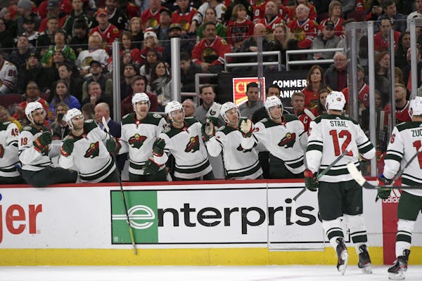 Eric Staal celebrated with the Wild bench after his 1,000th NHL point, a goal in Chicago on Sunday.
