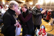 Lisa Kupcho, right, embraced friend Polly Posten after mass at St. Joan of Arc Church in Minneapolis. Kupcho travels 20 miles from Chanhassen to atten