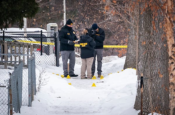 Investigators on the scene of a shooting where a man was shot and critically wounded by Minneapolis police responding to a domestic-related assault on
