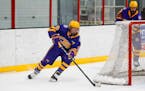 Cretin-Derham Hall's Jack Nei (10) goes for a wraparound attempt against Stillwater on Tuesday night. Nei had a goal for the Raiders in their 2-0 vict
