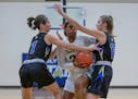 DeLaSalle's Nurjei Weems (22) split Holy Angels defenders Francesca Vascellaro (right) and Becky Little for two of her 22 points. Photo by Mark Hvidst