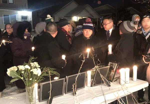 Several dozen people attended a candlelight vigil on Dec. 17, 2019, outside the home of Chiasher Fong Vue, who was shot and killed by Minneapolis poli