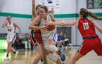 Wayzata's Jenna Johnson pushed her way through St. Croix Lutheran defenders Kenzie Maki (left) and Juel Skrien on the way to two of her game-high 23 p