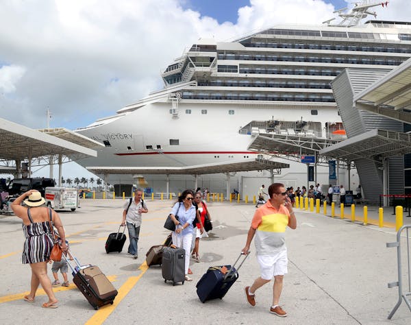 Passengers board Carnival’s Victory at the Port of Miami as they prepared to sail for Nassau.