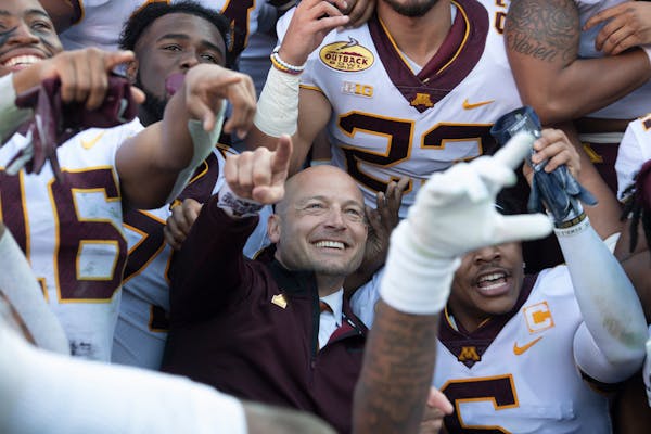 Gophers coach PJ Fleck celebrated with his players during a team photo following their Outback Bowl victory against Auburn.