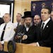 New York Gov. Andrew Cuomo, right, along with police, elected officials and community leaders, speaks Sunday, Dec. 29, 2019, at Ramapo Town Hall in Ra