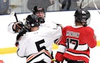 Moorhead's Michael Overbo celebrates with teammate Kai Holm (5) after Overbo scored one of his four goals Thursday against Lakeville North. Photo by L