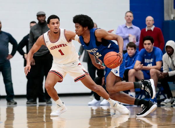 Two of Minnesota's top high school basketball players, Minnehaha Academy's Jalen Suggs (1) and Hopkins' Kerwin Walton, faced each other in a December 