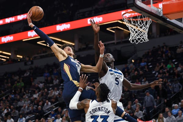 New Orleans center Jaxson Hayes went up for a dunk against Wolves center Gorgui Dieng (5) and over forward Robert Covington during the second half We