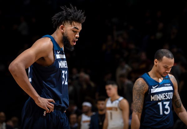 Timberwolves center Karl-Anthony Towns (32) and point guard Shabazz Napier walked off the court after a 107-100 loss to the Nuggets at Target Center o