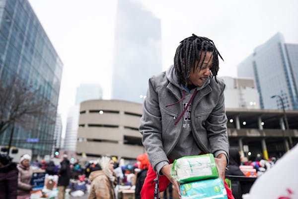 Volunteer Robert Hill of Minneapolis helped load donations onto trucks Wednesday as displaced Francis Drake residents were bused to temporary shelters