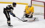 A close-range shot by Andover's Luke Kron is stopped by Rosemount goaltender Will Tollefson during Thursday's game at the St. Louis Park Rec Center. P