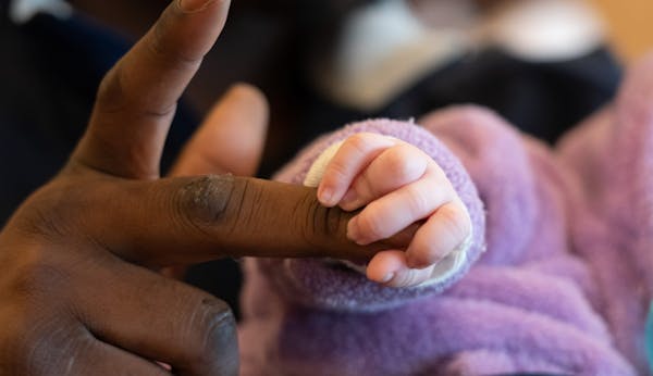 Five-week-old Chanel held the finger of her father, Jamal Jones.