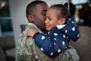 Deonte Haynes hugged his daughter, Jalei, 5, in early December at Minneapolis-St. Paul International Airport, where he was leaving to return to Fort H
