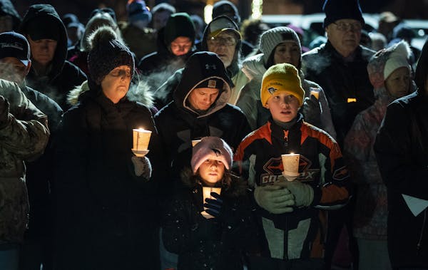 The Mann family of Waseca were among the hundreds of people attending the candlelight vigil Thursday for injured police officer Arik Matson. From left