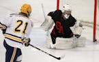 Bloomington Kennedy junior forward Connor Martin fired a shot at Gentry Academy goalie Alex Timmons during the Eagles' 7-3 loss in the Herb Brooks Hol