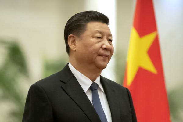 In this Jan. 6, 2020, photo, Chinese President Xi Jinping stands during a welcome ceremony for Kiribati's President Taneti Maamau at the Great Hall of