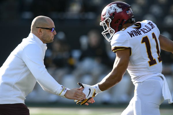 Gophers coach P.J. Fleck high-fived defensive back Antoine Winfield Jr. before this season's game against Iowa.