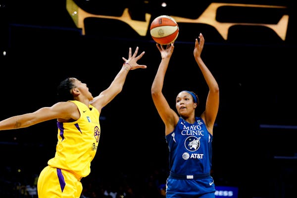 The Lynx's Napheesa Collier shoots while defended by Los Angeles Sparks' Candace Parker earlier this month.