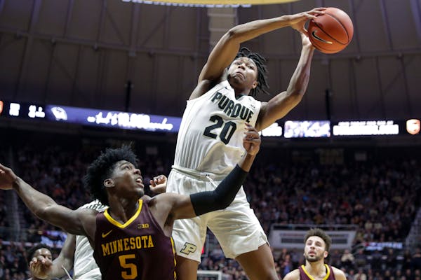 Purdue guard Nojel Eastern grabbed a rebound over Gophers guard Marcus Carr during the second half Thursday.