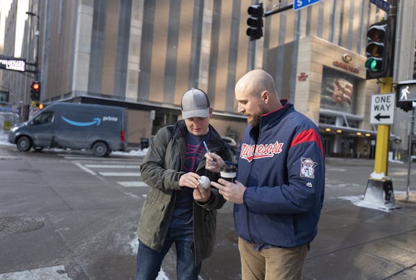 Twins manger Rocco Baldelli autographed a baseball for Reed Marquardt in downtown Minneapolis on Monday.