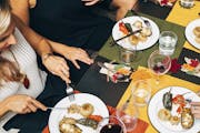 Guests eat at a dinner organized by Eatwith, a communal dining service that is now in more than 200 cities.