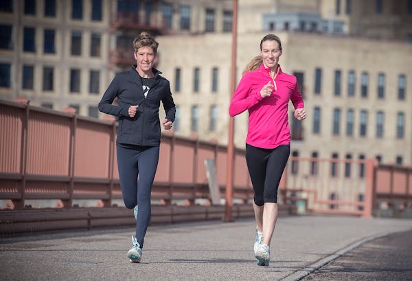 Carrie Tollefson, right, made her way across the Stone Arch Bridge for an early morning run May 2, 2017.