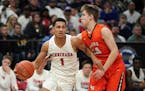 Minnehaha guard Jalen Suggs (1) drove to the basket as Lake City guard Justin Wohlers (14) tried to swat the ball away in a Class 2A state tournament 