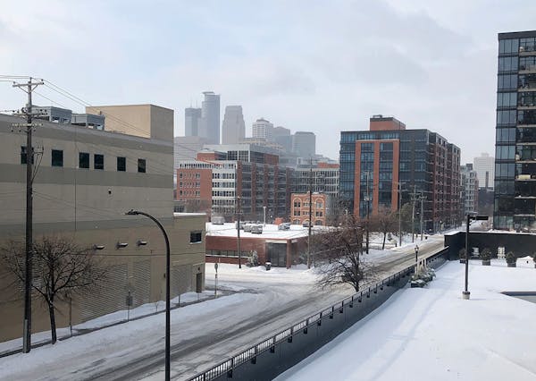 A view of downtown Minneapolis from the Mill District on Saturday. The snow has stopped but winds have increased, and streets remain icy.