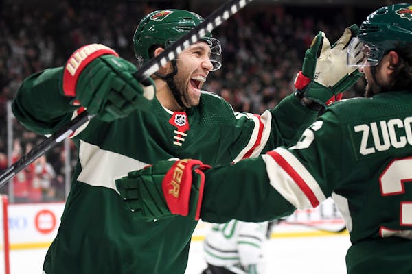 Wild left winger Jason Zucker, left, celebrated with right winger Mats Zuccarello after Zuccarello's second-period goal in a 7-0 rout of the Dallas St
